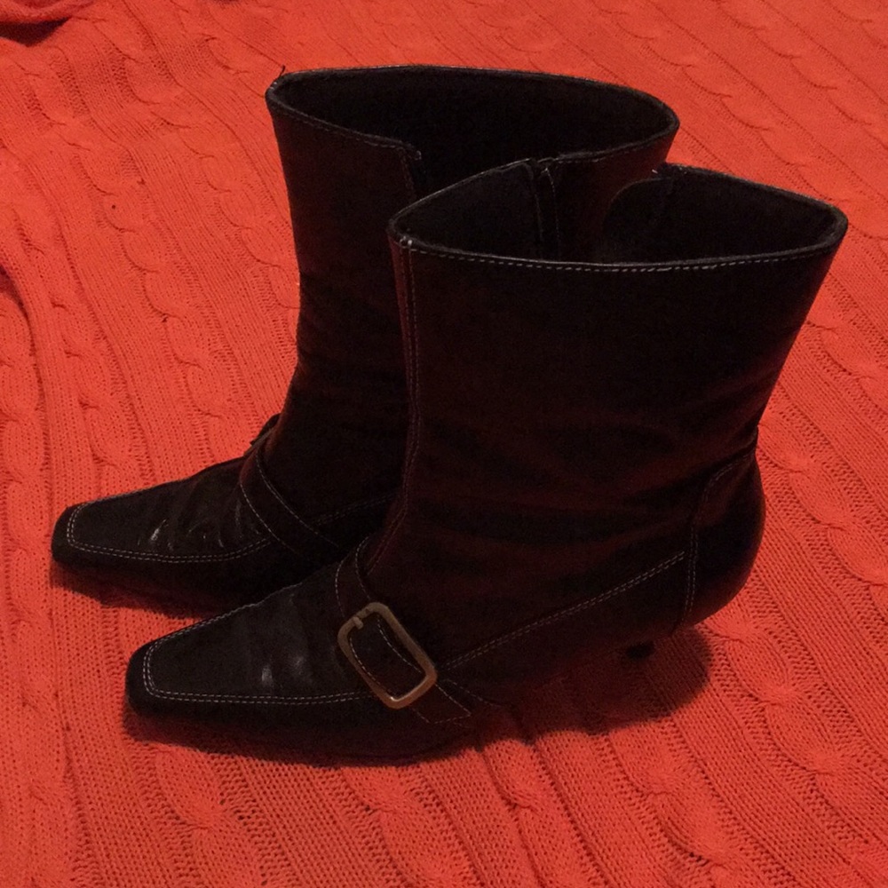 Versatile black leather bootie with buckle detail.